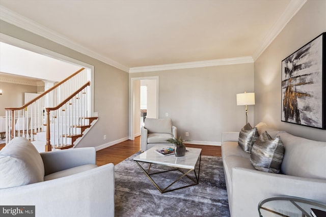 living room with stairway, baseboards, wood finished floors, and crown molding