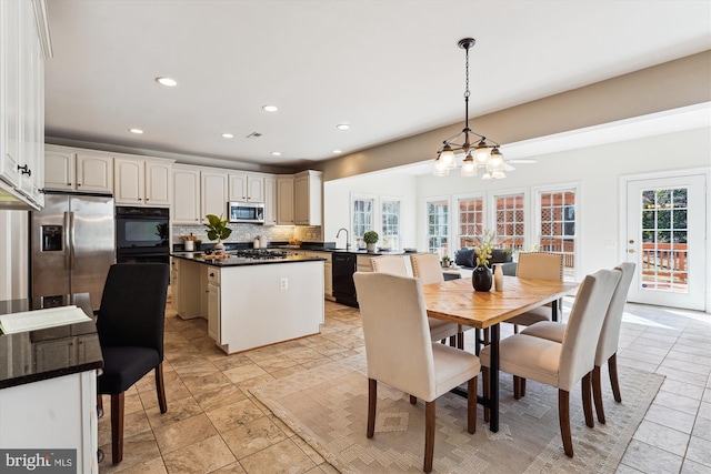 dining space with a chandelier, recessed lighting, and light tile patterned flooring