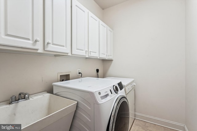 laundry area with hookup for a washing machine, baseboards, cabinet space, electric dryer hookup, and a sink