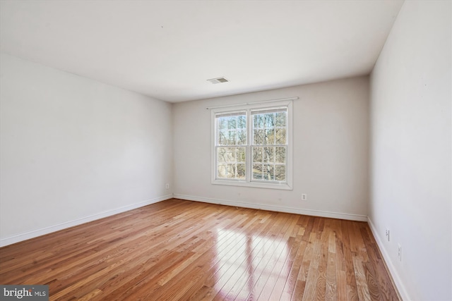 unfurnished room with visible vents, baseboards, and light wood-style flooring