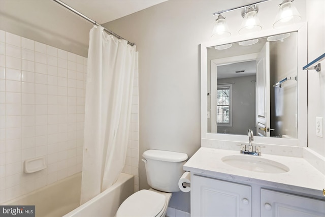 bathroom with vanity, shower / bath combination with curtain, and toilet