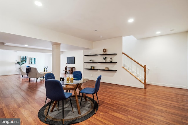 dining area featuring recessed lighting, stairs, baseboards, and wood finished floors