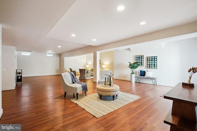 living area featuring recessed lighting, baseboards, and wood finished floors