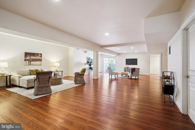 living room with visible vents, recessed lighting, baseboards, and wood finished floors