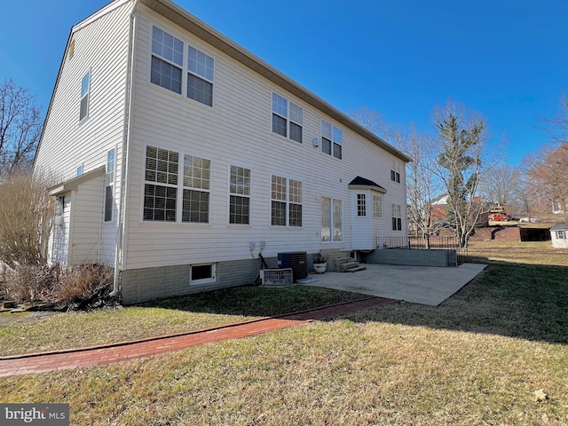 back of house with a patio area, a lawn, cooling unit, and entry steps