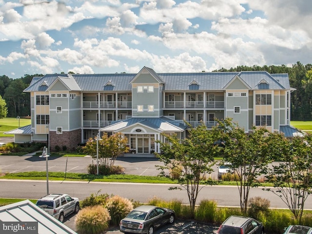 view of building exterior featuring a residential view and uncovered parking