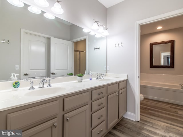 33565 Windswept Dr Unit 10201, Millsboro, DE 19966 - bathroom featuring a sink, toilet, wood finished floors, and double vanity