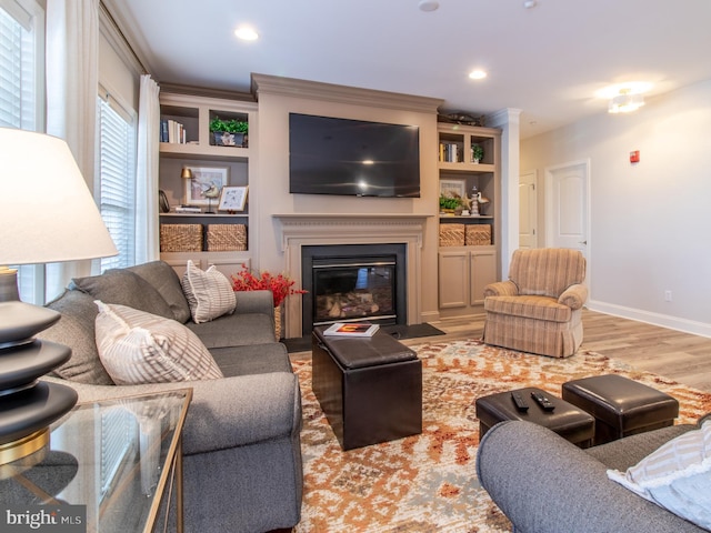 33565 Windswept Dr Unit 10201, Millsboro, DE 19966 - living room with a fireplace with flush hearth, wood finished floors, baseboards, and ornamental molding