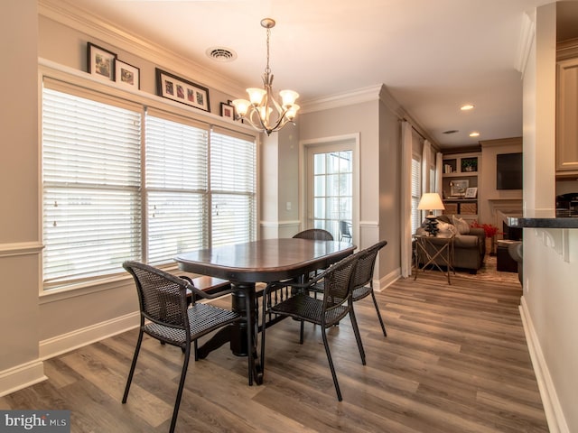 33565 Windswept Dr Unit 10201, Millsboro, DE 19966 - dining room featuring baseboards, visible vents, dark wood-type flooring, crown molding, and a chandelier