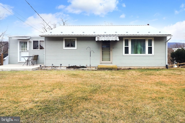 back of house with a patio, metal roof, and a yard