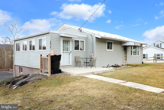 back of property with a patio area, a yard, and fence