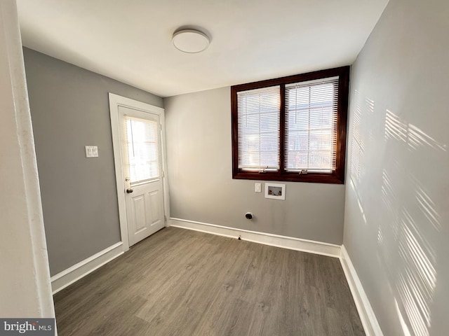 interior space featuring baseboards, wood finished floors, hookup for a washing machine, and laundry area