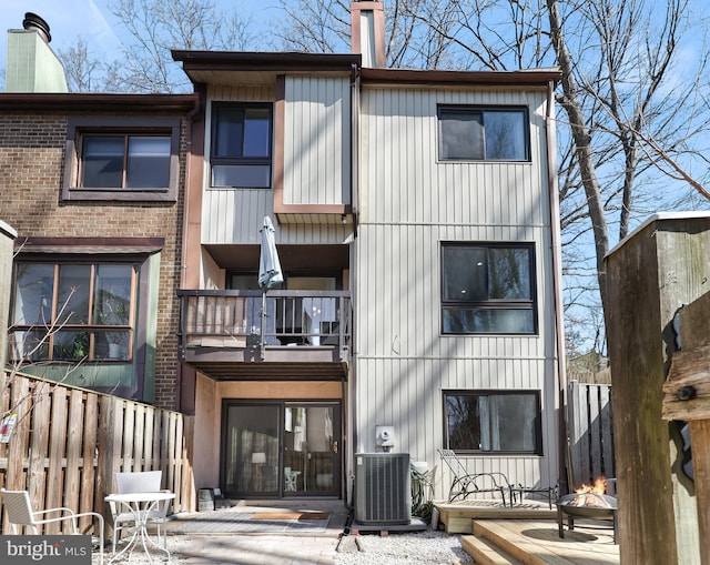 exterior space featuring central AC unit and fence