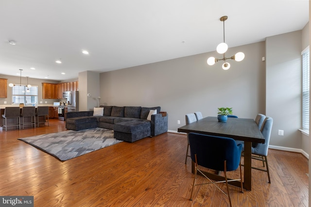 12831 Clarksburg Square Rd, Clarksburg, MD 20871 - dining room featuring wood finished floors, a notable chandelier, baseboards, and recessed lighting