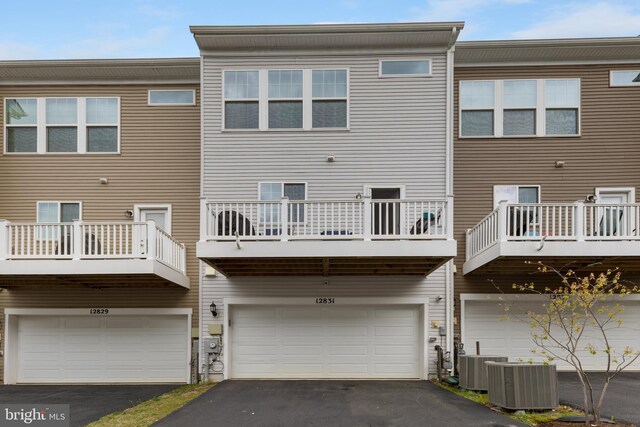 12831 Clarksburg Square Rd, Clarksburg, MD 20871 - back of property featuring a garage, aphalt driveway, and central AC