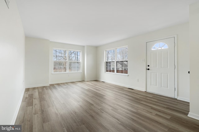 entryway with visible vents, baseboards, and wood finished floors