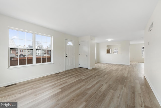 entryway with visible vents, plenty of natural light, and light wood-type flooring