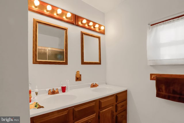 full bathroom with a sink and double vanity