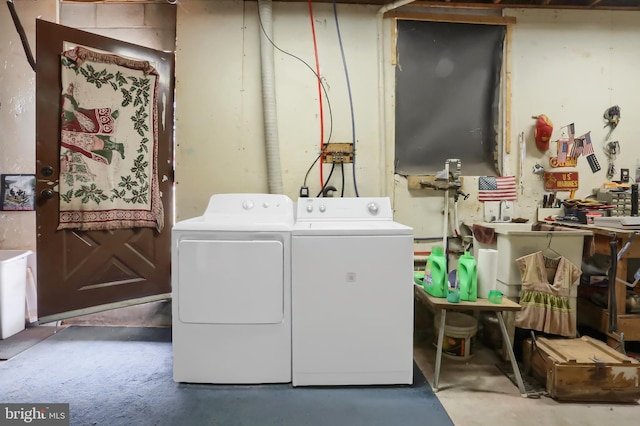 clothes washing area featuring independent washer and dryer and laundry area