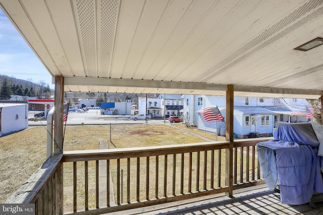 wooden deck with a lawn