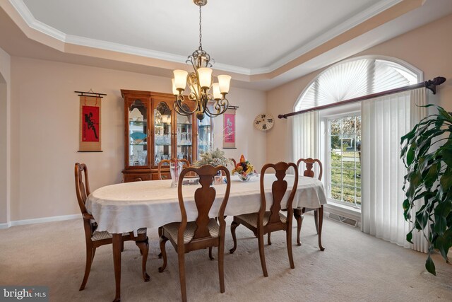 dining area featuring visible vents, a tray ceiling, crown molding, light colored carpet, and a chandelier