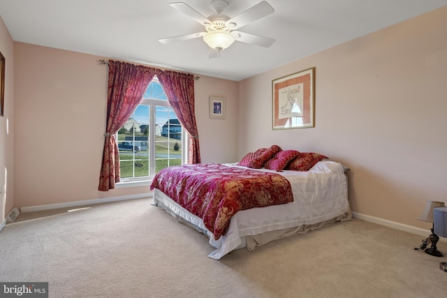 bedroom with baseboards, carpet floors, and ceiling fan