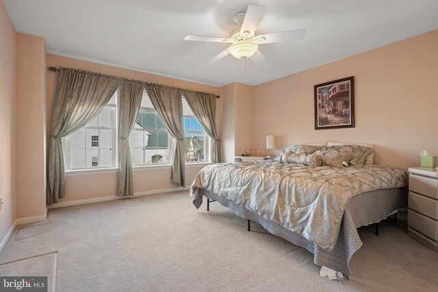 bedroom with baseboards, light colored carpet, and ceiling fan