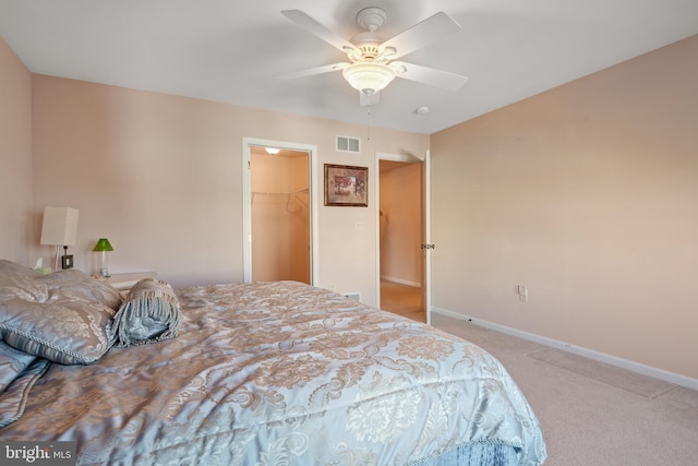 bedroom with visible vents, baseboards, ceiling fan, carpet flooring, and a closet