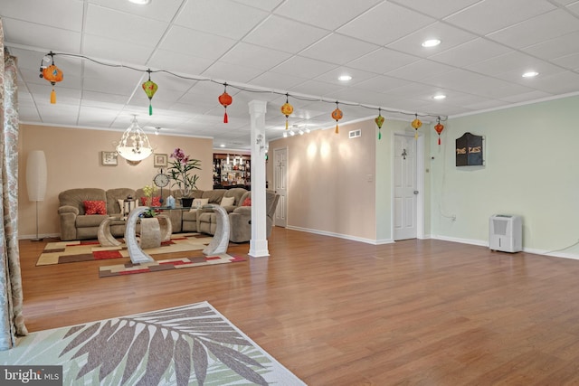 living room featuring visible vents, crown molding, baseboards, recessed lighting, and wood finished floors