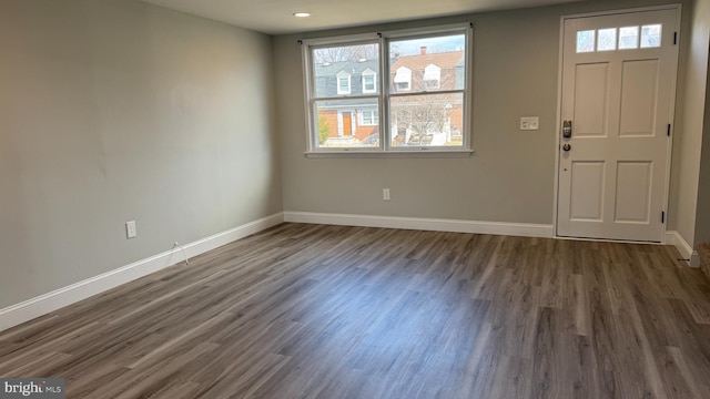 foyer with baseboards and dark wood-style floors