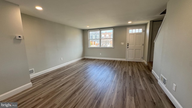 foyer entrance featuring visible vents, recessed lighting, dark wood-style floors, and baseboards