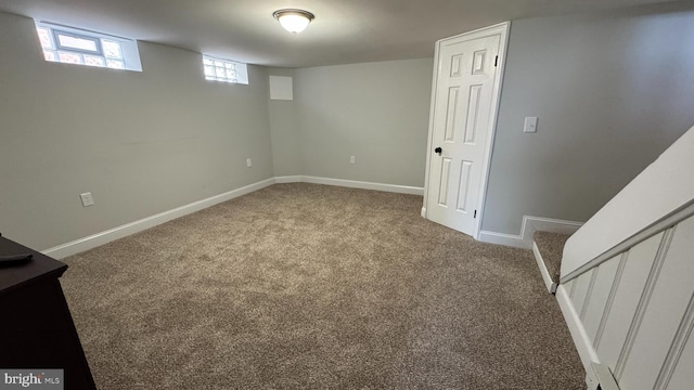 basement featuring stairway, baseboards, and carpet floors