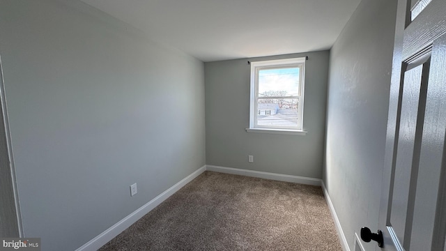 carpeted spare room with baseboards