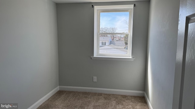 empty room with carpet and baseboards