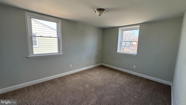 carpeted spare room with baseboards