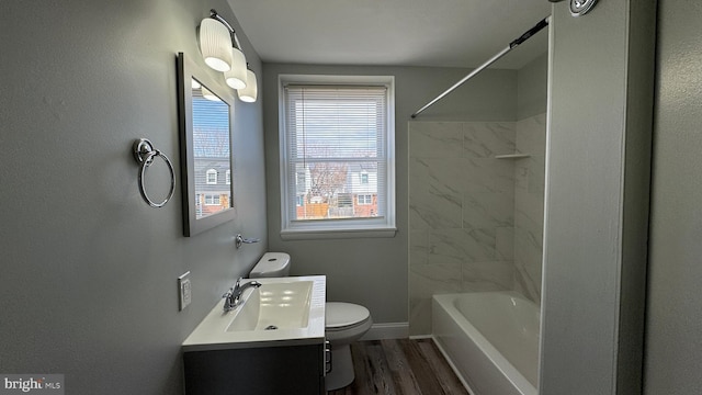 full bathroom featuring vanity, wood finished floors, baseboards, toilet, and shower / bathtub combination