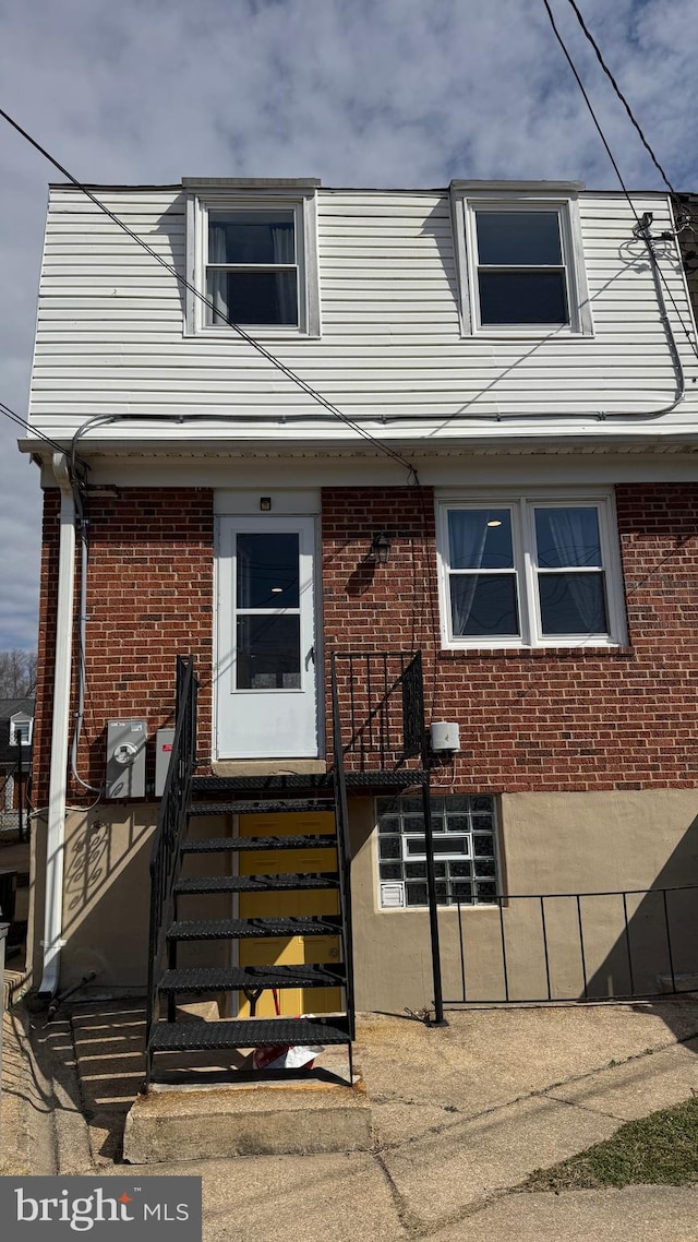 view of front facade featuring brick siding and entry steps