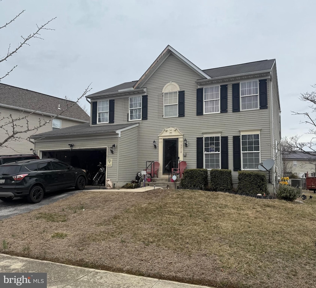 colonial inspired home featuring a front yard and driveway