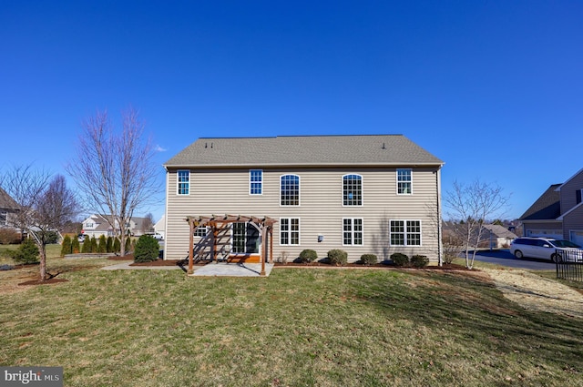 back of house featuring a patio area, a lawn, a shingled roof, and a pergola