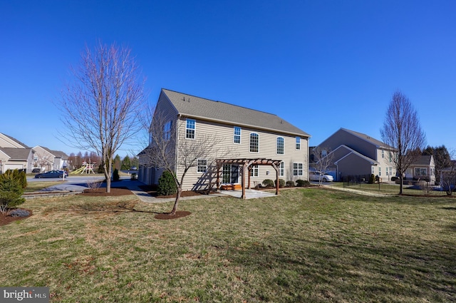 rear view of house featuring a lawn, a pergola, and a patio