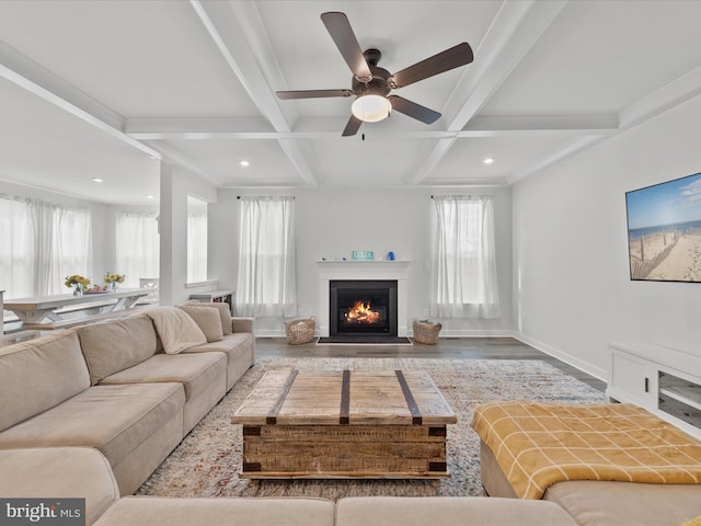 living room featuring baseboards, plenty of natural light, coffered ceiling, and beam ceiling