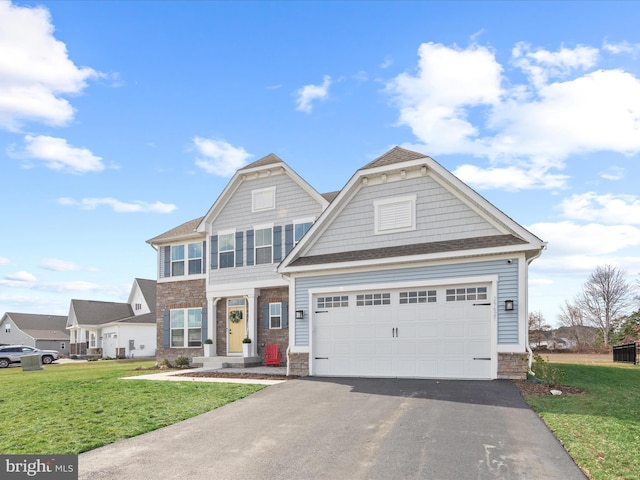 view of front of property featuring stone siding, driveway, an attached garage, and a front yard