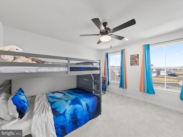 bedroom with carpet flooring, a ceiling fan, and baseboards