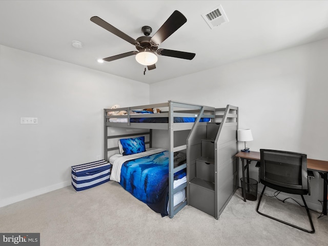 carpeted bedroom with visible vents, a ceiling fan, and baseboards