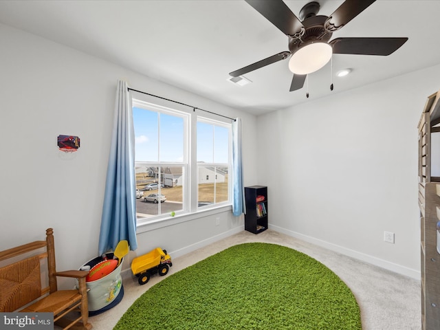 interior space featuring visible vents, baseboards, and ceiling fan