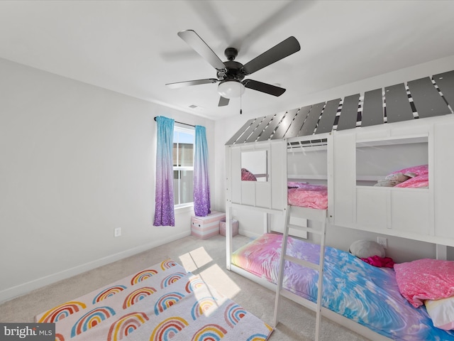 carpeted bedroom with visible vents, baseboards, and ceiling fan