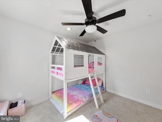 bedroom with ceiling fan, baseboards, and carpet