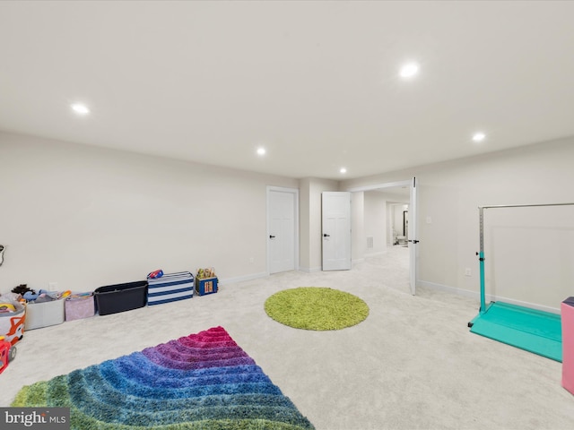 interior space with recessed lighting, light colored carpet, and baseboards