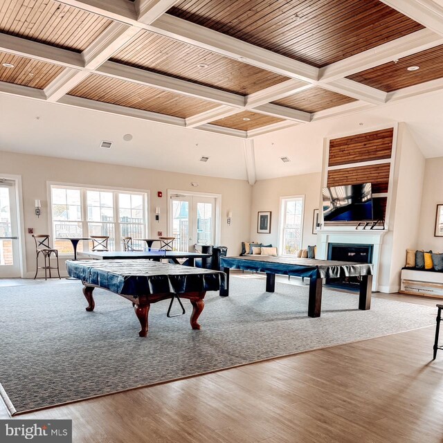 game room with a fireplace, wood ceiling, coffered ceiling, and wood finished floors