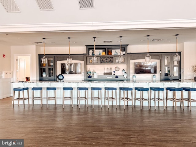 bar featuring visible vents and wood finished floors